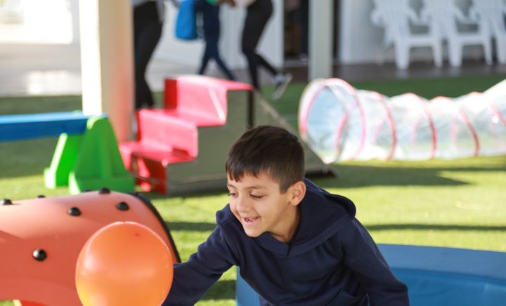 Student chasing a balloon in the playground
